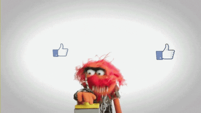 animated gif of a muppet hitting a button which is generating thumbs up emojis