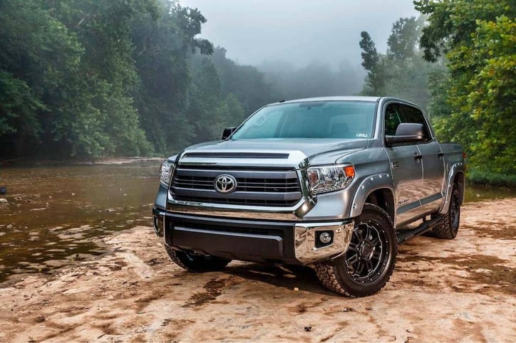 Picture of a Silver Toyota Tundra on the bank of a river